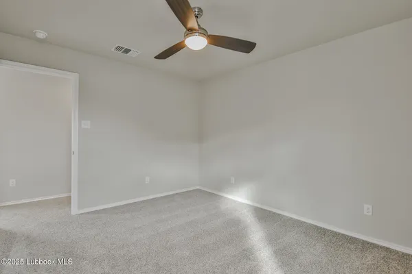 a view of an empty room with a fan