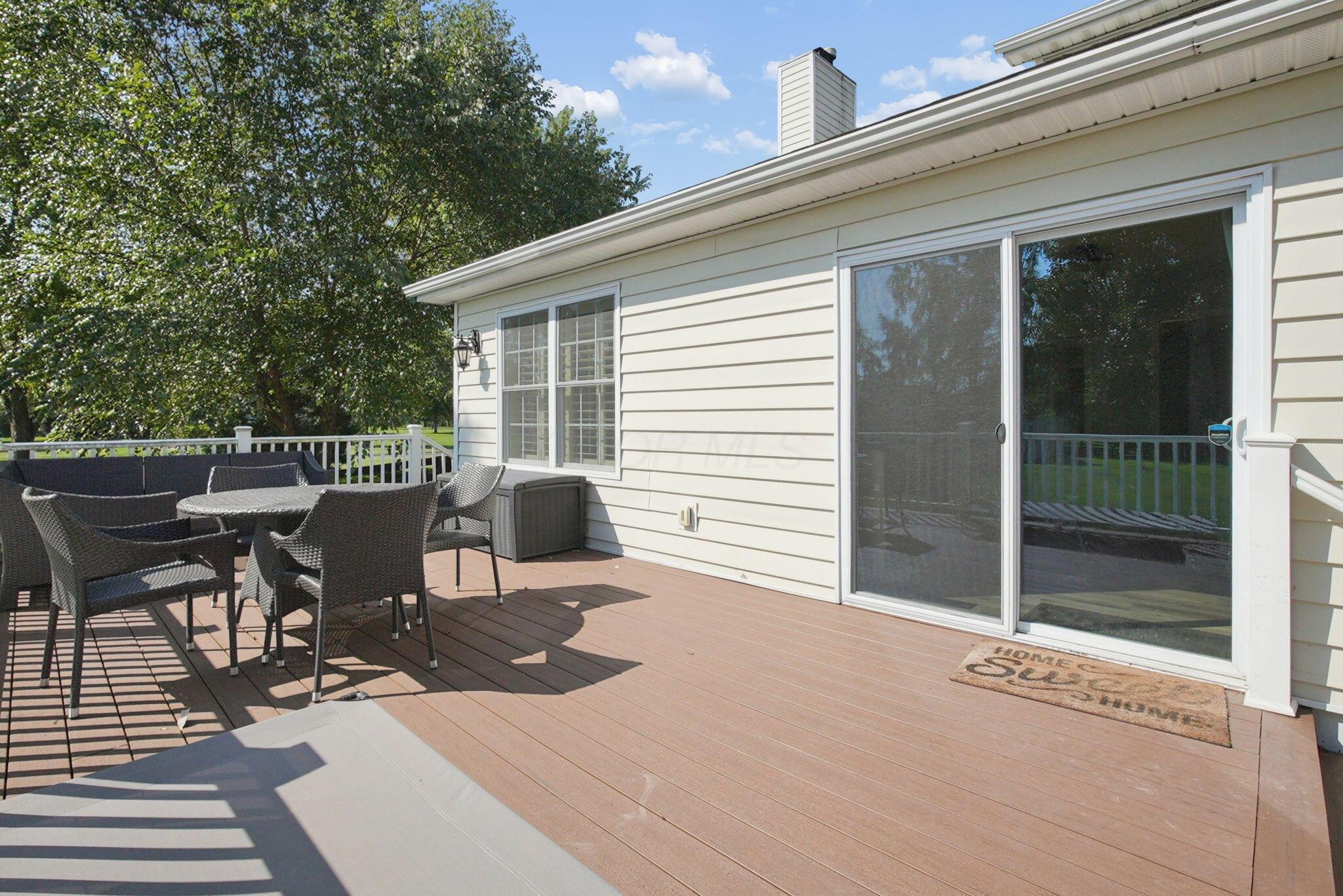 9435 Concord Road Powell, OH 43065 - Photo 64 of 77 Expansive exterior deck featuring composite decking, white railing, and a sliding glass door