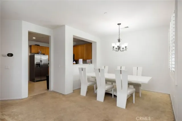 a kitchen with stainless steel appliances granite countertop a stove a sink dishwasher and a refrigerator