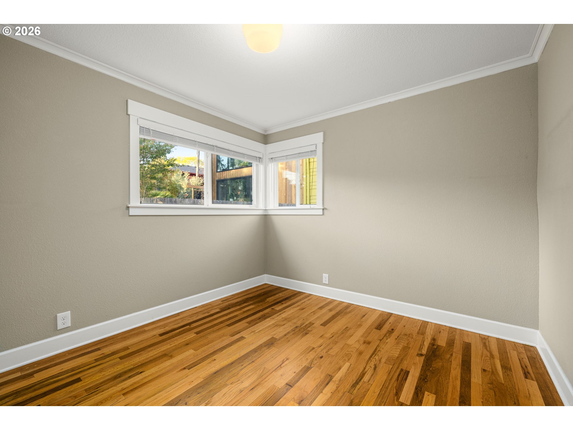 4117 Southeast Henderson Street Portland, OR 97202 - Photo 21 of 43 a view of an empty room with wooden floor and a window
