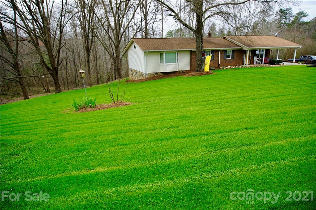 3038 Dravo Road Shelby, NC 28152 - Photo 2 of 33 a front view of a house with a garden and trees