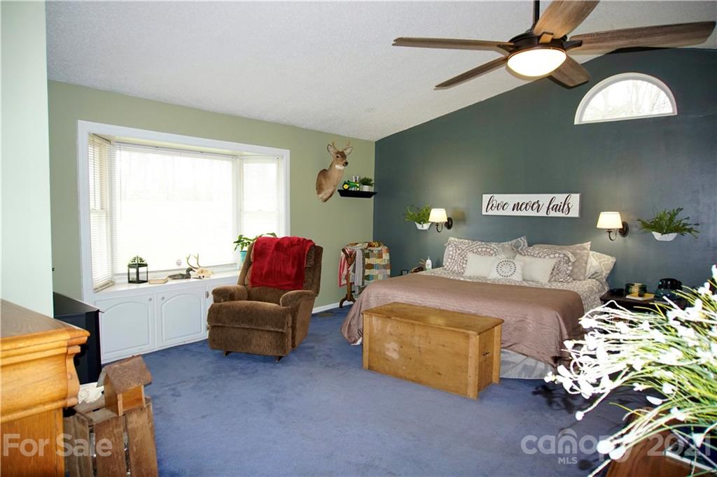 3038 Dravo Road Shelby, NC 28152 - Photo 15 of 33 a bedroom with a bed and a chandelier