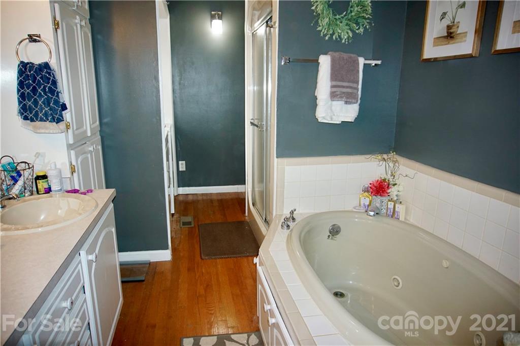 3038 Dravo Road Shelby, NC 28152 - Photo 18 of 33 a bathroom with a tub sink and mirror