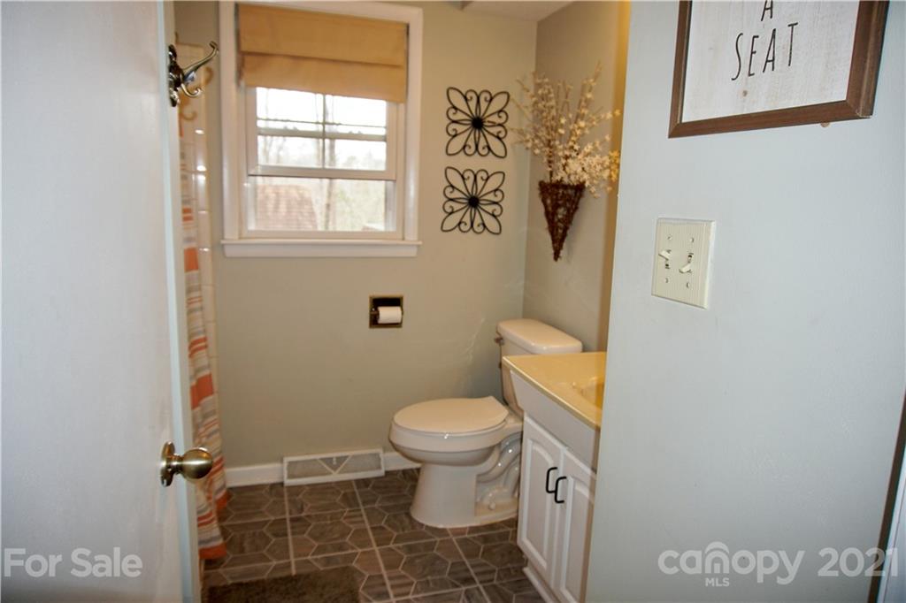 3038 Dravo Road Shelby, NC 28152 - Photo 10 of 33 a white toilet sitting next to a bathroom sink