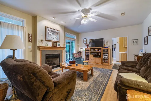 a view of a kitchen area with furniture and wooden floor