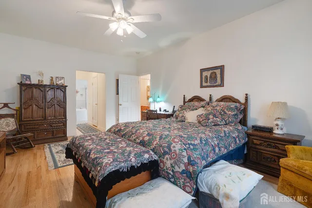 a bathroom with a granite countertop toilet sink and mirror