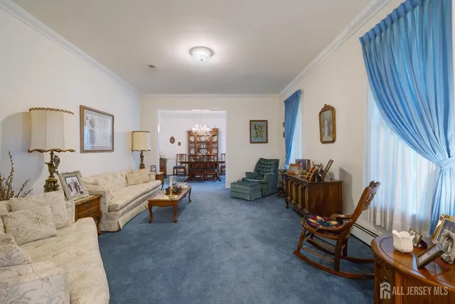 a view of a dining room with furniture and a chandelier