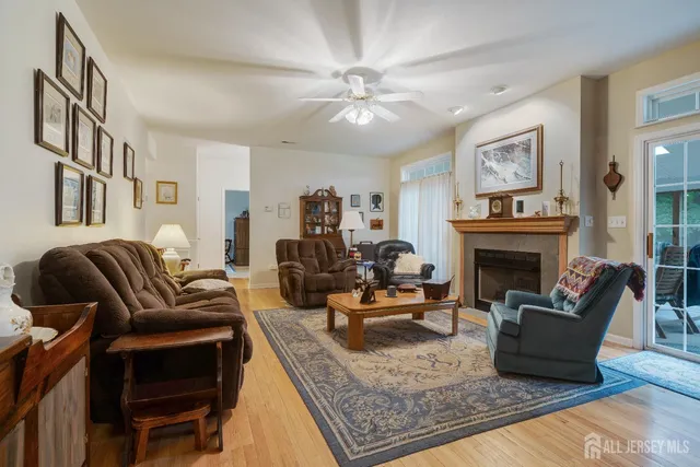 a kitchen with stainless steel appliances kitchen island granite countertop a stove a sink dishwasher and a refrigerator with wooden floor