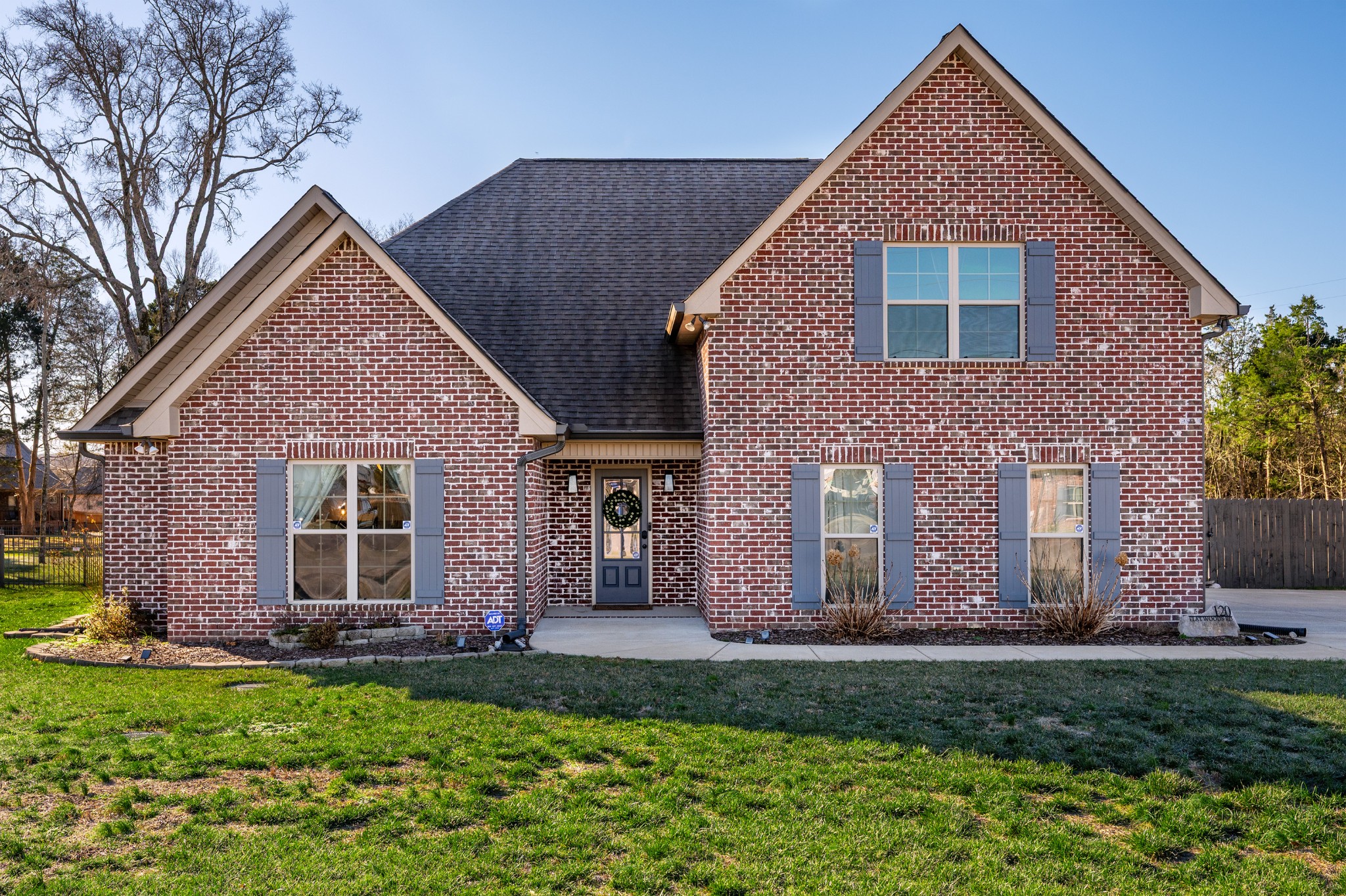 a front view of a house with a garden