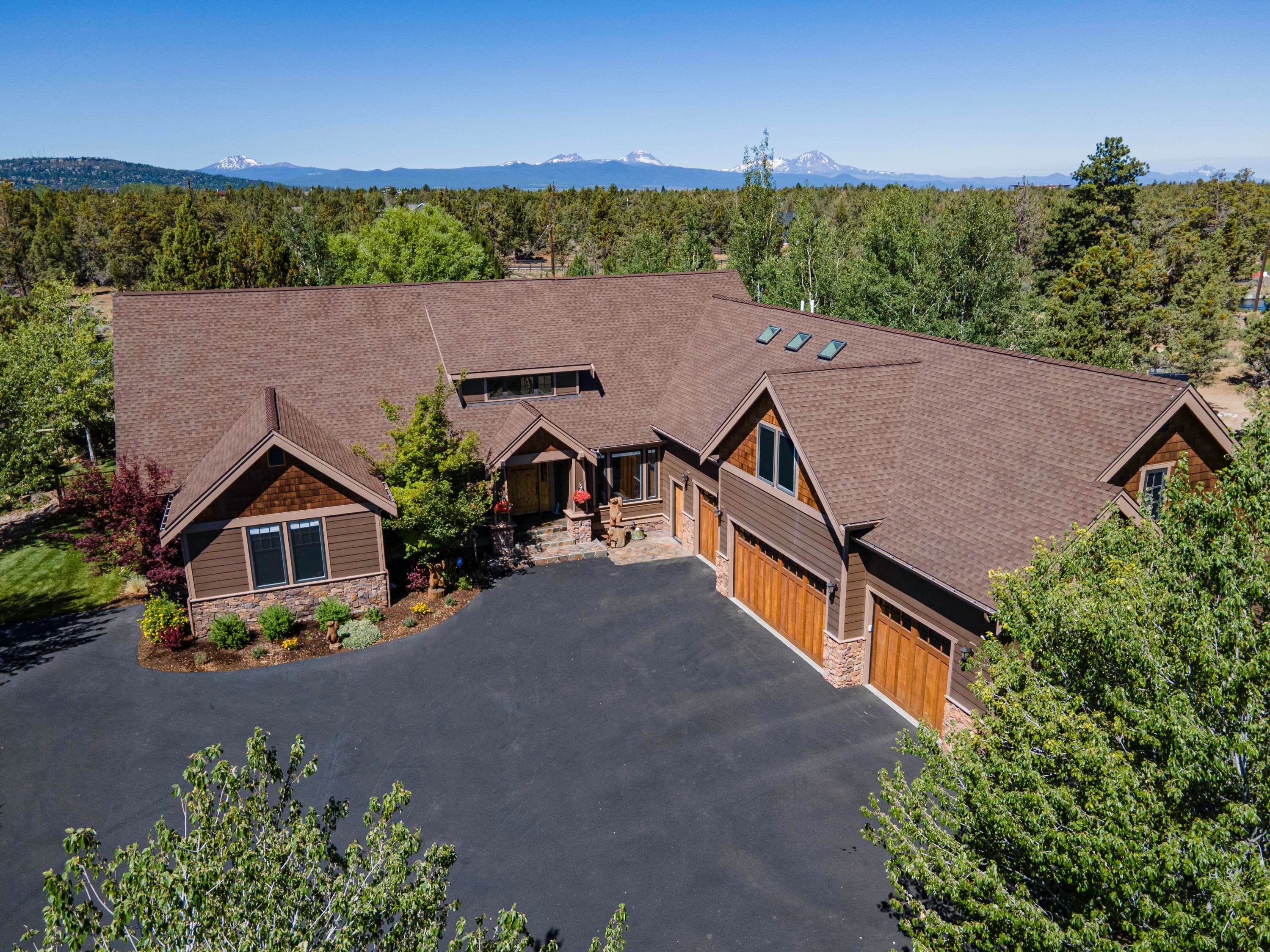 63545 Overtree Road Bend, OR 97701 - Photo 1 of 63 Paved street, driveway with tons of parking outside the 4 car garage!