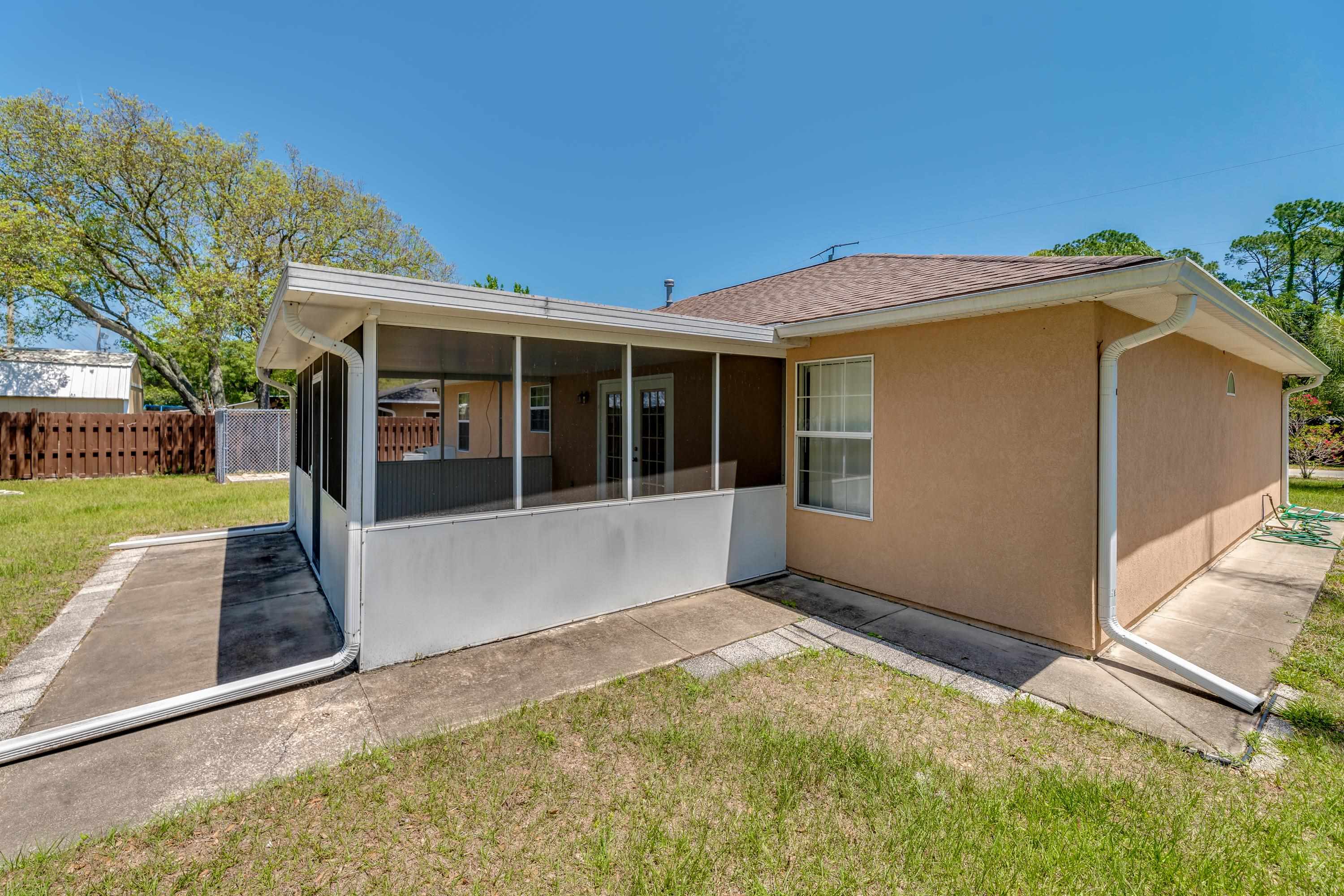 112 Gentian Road St. Augustine, FL 32086 - Photo 12 of 33 a view of a house with a small yard and a large tree