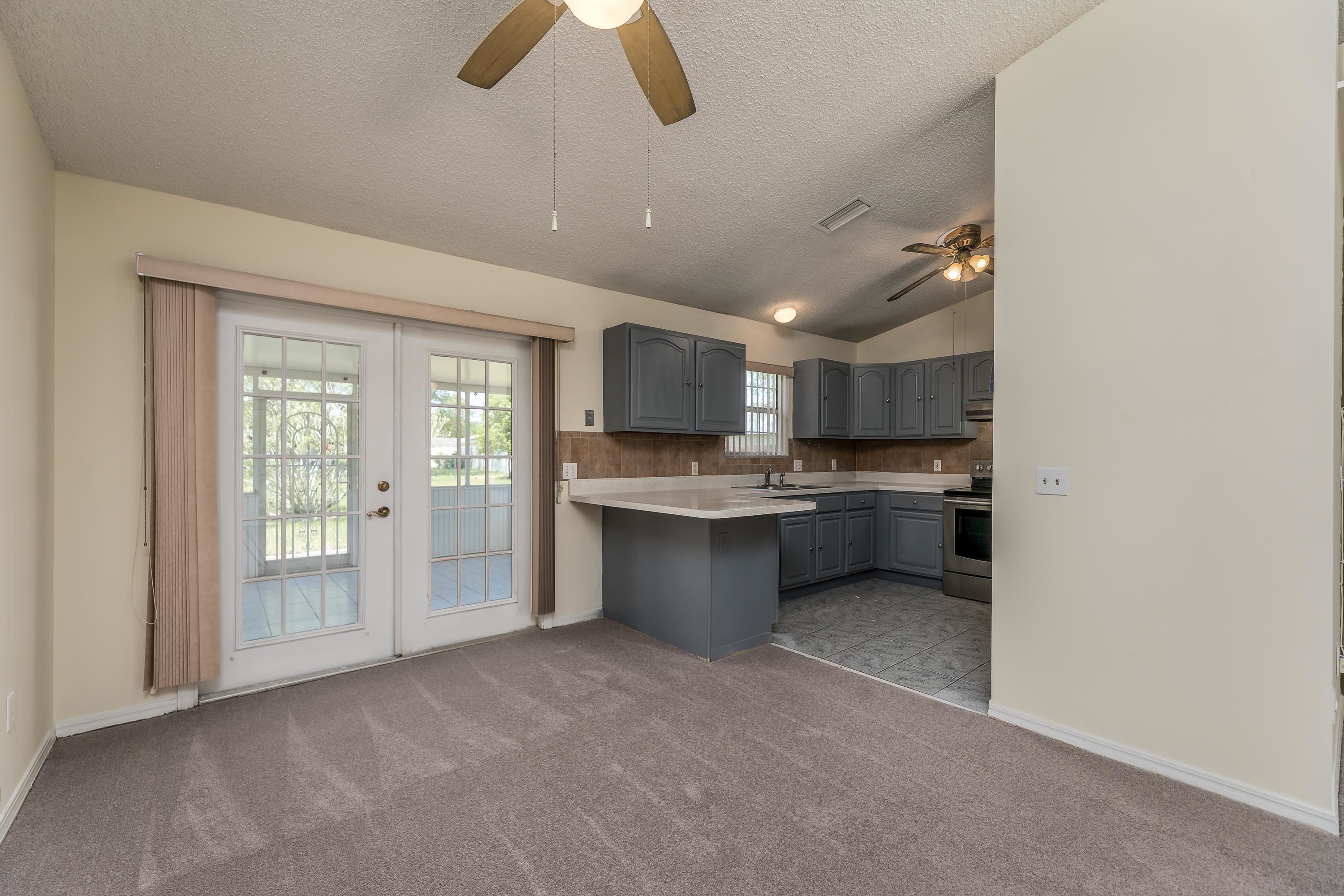 112 Gentian Road St. Augustine, FL 32086 - Photo 18 of 33 a view of a kitchen with a sink and dishwasher a refrigerator with wooden floor
