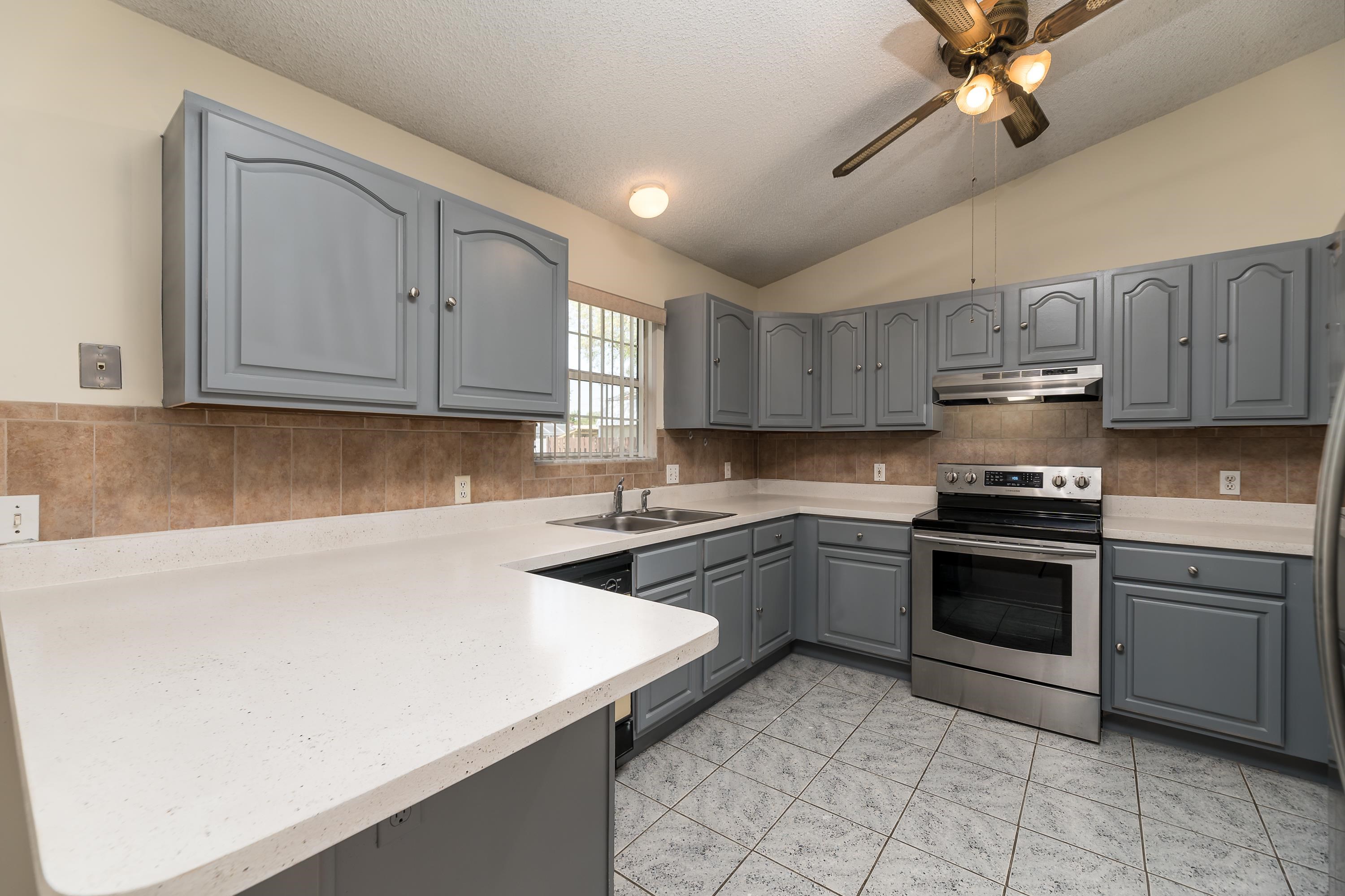 112 Gentian Road St. Augustine, FL 32086 - Photo 20 of 33 a kitchen with stainless steel appliances granite countertop a sink a stove top oven and cabinets