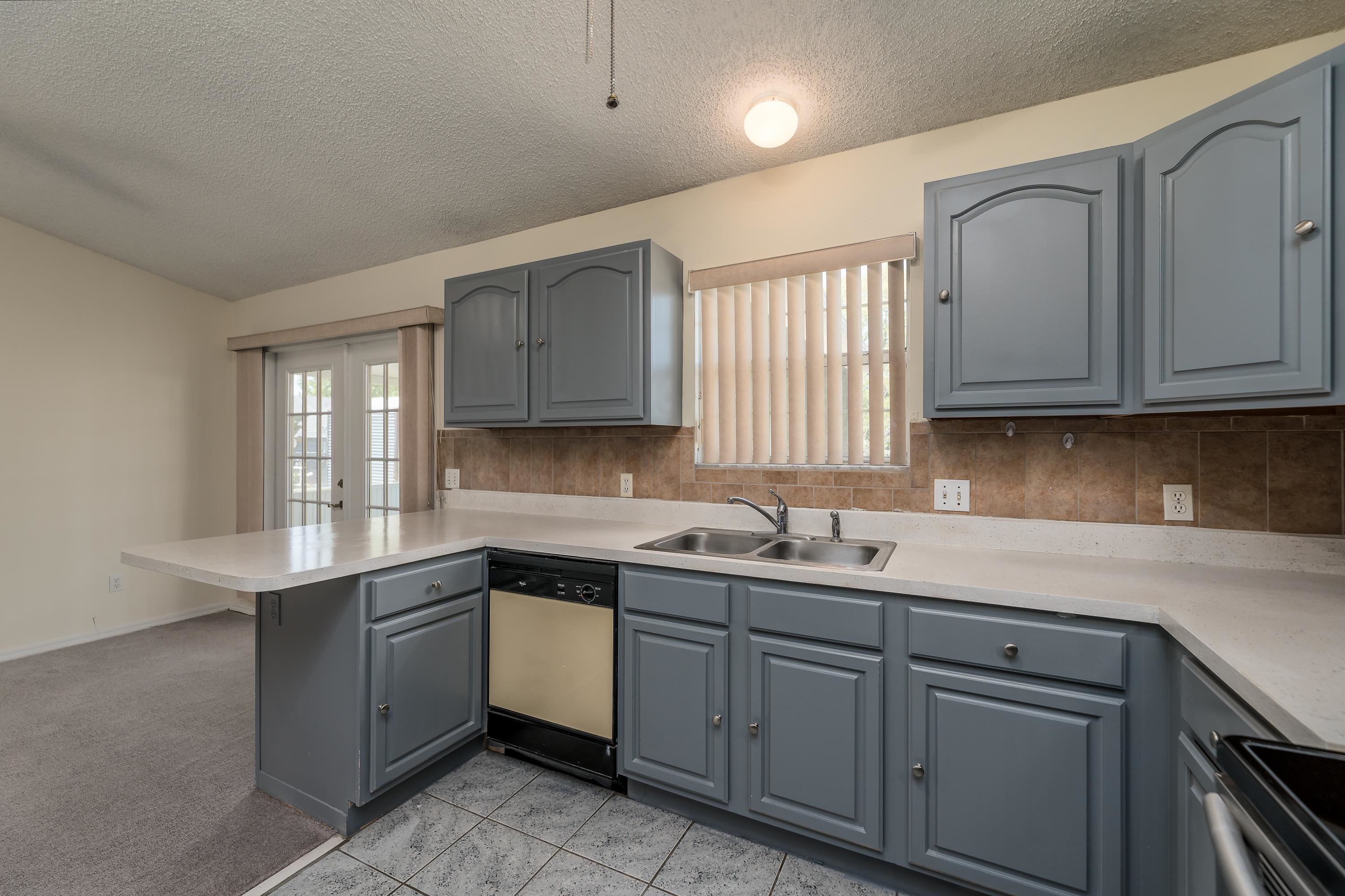 112 Gentian Road St. Augustine, FL 32086 - Photo 21 of 33 a kitchen with a sink dishwasher window and cabinets