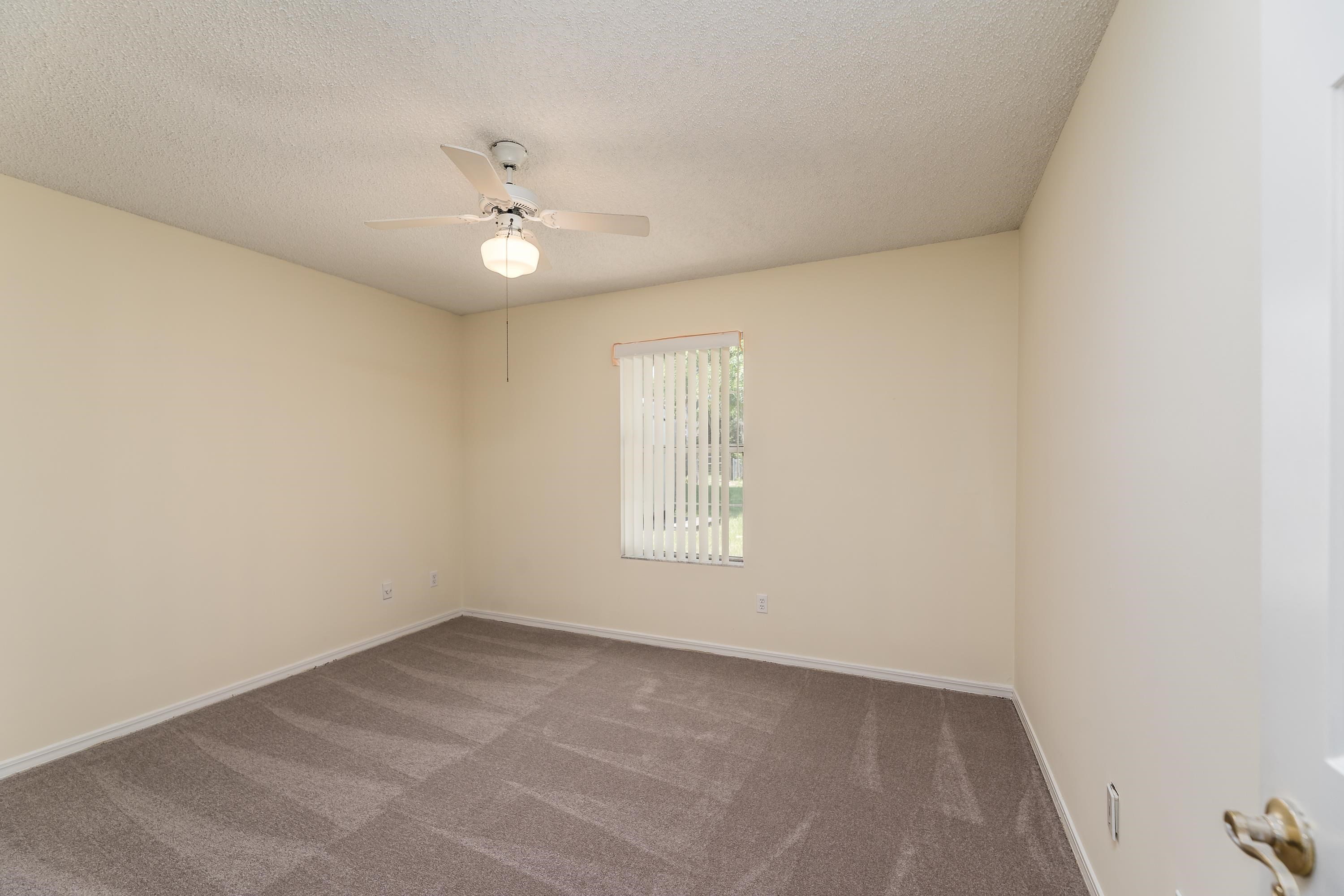 112 Gentian Road St. Augustine, FL 32086 - Photo 25 of 33 an empty room with a window and ceiling fan
