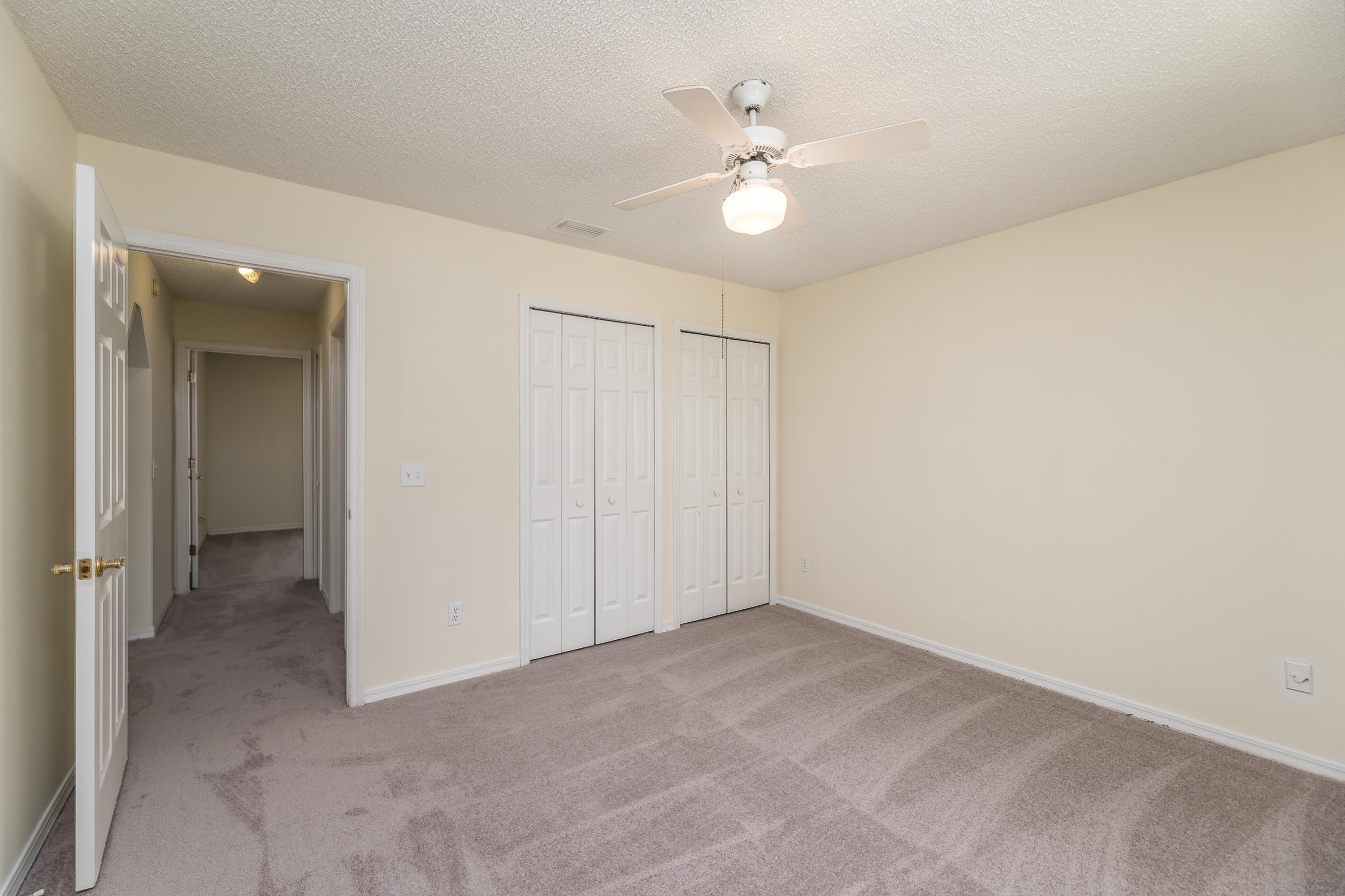112 Gentian Road St. Augustine, FL 32086 - Photo 26 of 33 an empty room with a chandelier fan and fan