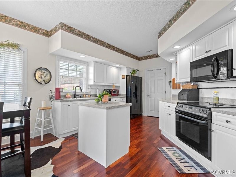 225 Lighthouse Pointe Hopewell, VA 23860 - Photo 15 of 32 a kitchen with white cabinets and stainless steel appliances