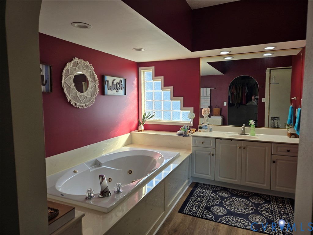 225 Lighthouse Pointe Hopewell, VA 23860 - Photo 22 of 32 a bathroom with a bathtub sink and mirror