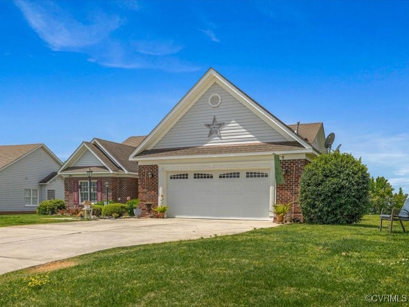 225 Lighthouse Pointe Hopewell, VA 23860 - Photo 3 of 32 a front view of a house with a yard and garage