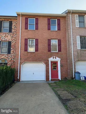 a front view of a building with a garden