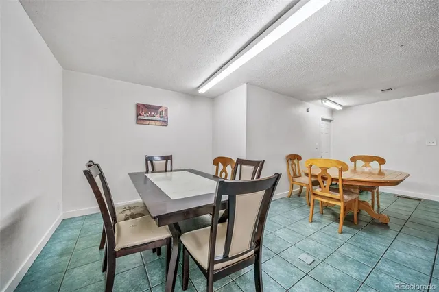 a view of a dining room with furniture and a table