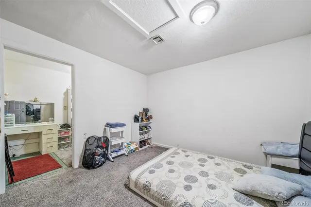a bedroom with bed and a chandelier