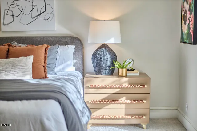 a bedroom with a bed and lamp