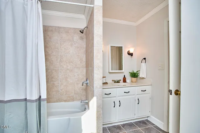 a bathroom with a double vanity sink mirror and shower