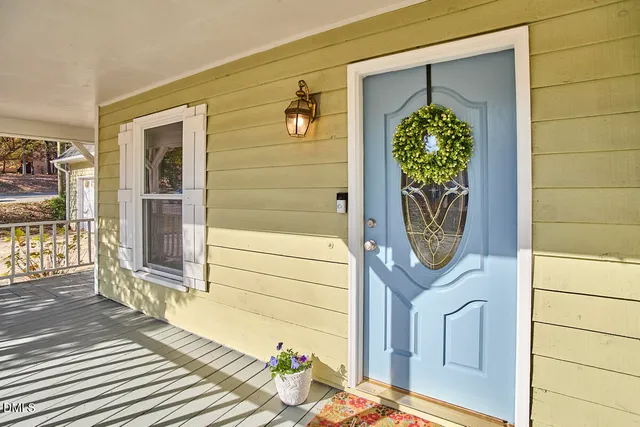 a front view of a house with a potted plant and a window