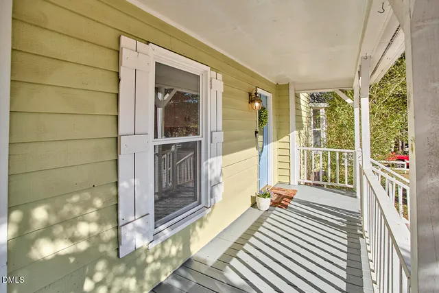 a view of a balcony with wooden floor and door