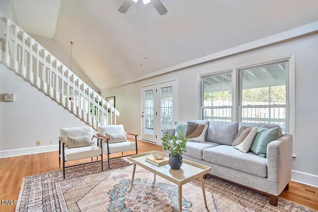 a living room with furniture and wooden floor