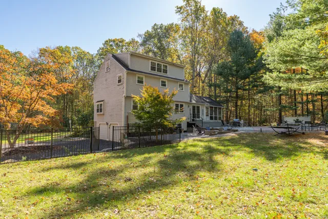 a view of a house with swimming pool and sitting area