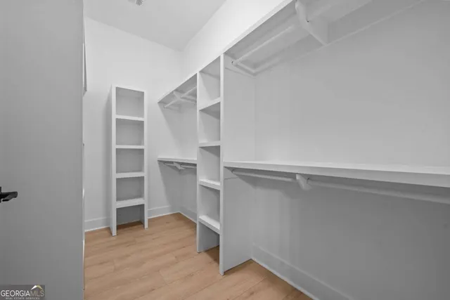 a view of an empty room with window and fire place