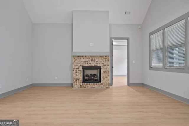 a kitchen with a sink a center island and wooden floor