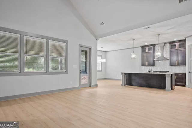 a kitchen with stainless steel appliances granite countertop a stove and a microwave