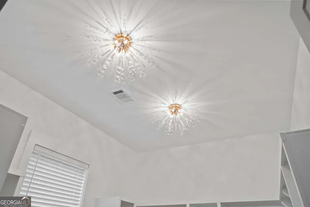 a view of a big room with a ceiling fan