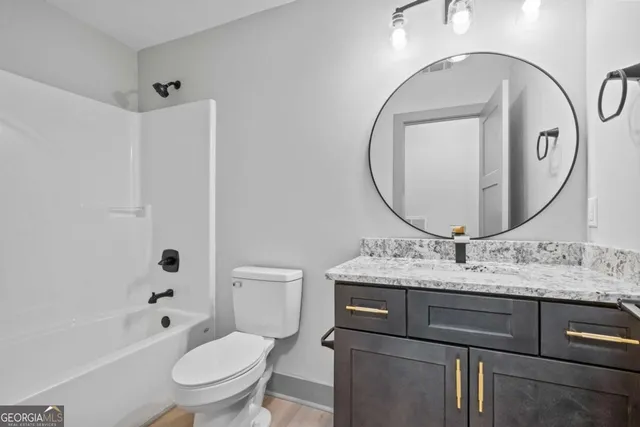 an aerial view of a house with a yard and lake view