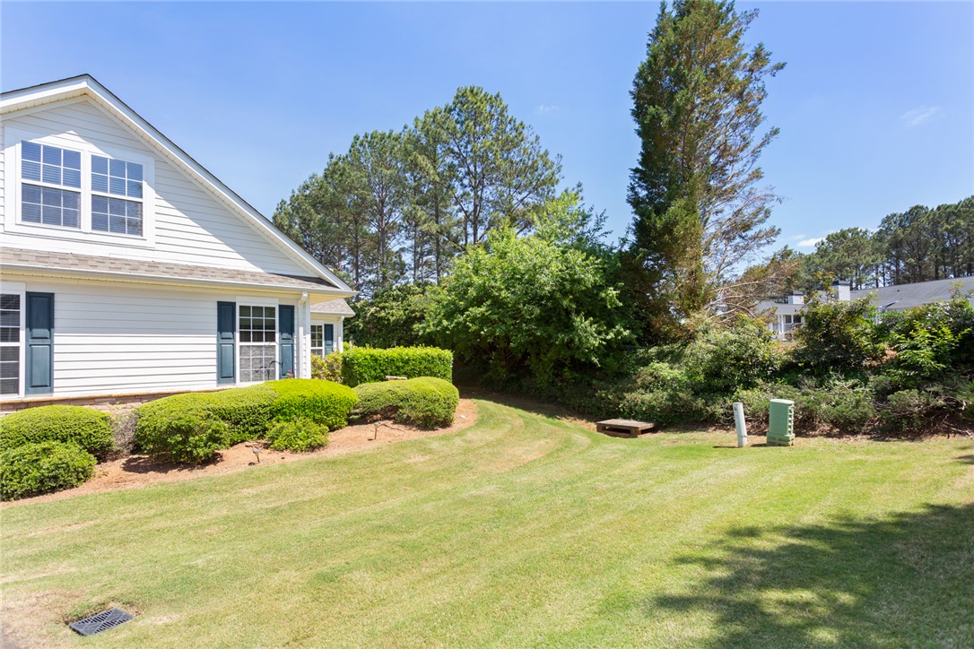 155 Life Style Lane Anderson, SC 29621 - Photo 38 of 49 This charming residence features a well-maintained lawn and verdant landscaping, offering a serene outdoor environment.