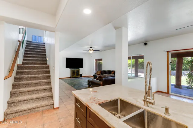 a kitchen with sink and refrigerator