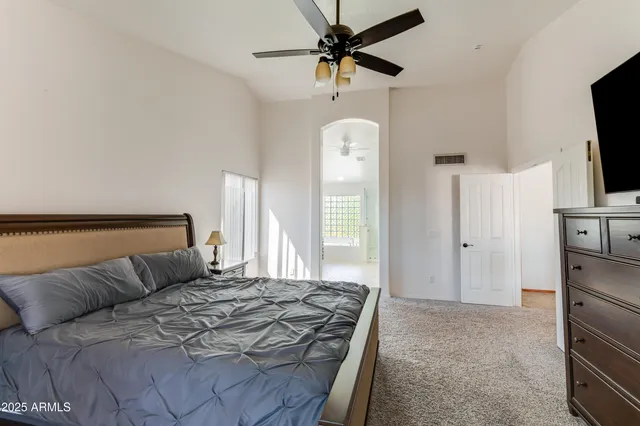 a bedroom with a bed and a television