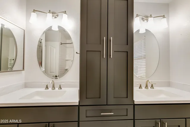 a bathroom with a sink a mirror and shower