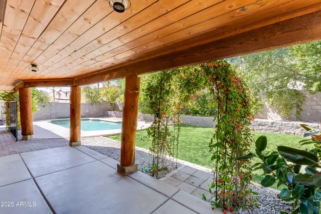 a view of a porch with couches and wooden fence