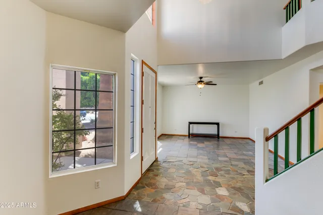 an empty room with windows and closet
