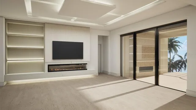 a view of an empty room with furniture and a window