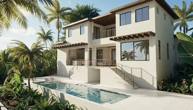 a view of a white house with a large windows and a yard in front of it