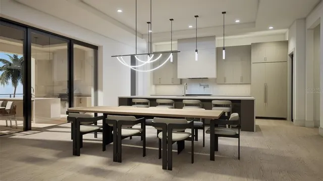 a kitchen with stainless steel appliances granite countertop a table chairs sink refrigerator and microwave