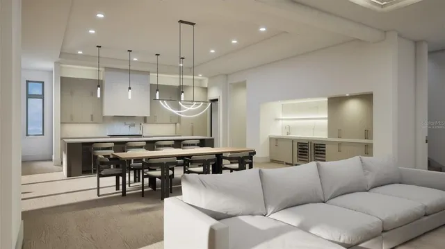 a living room with furniture kitchen view and a chandelier