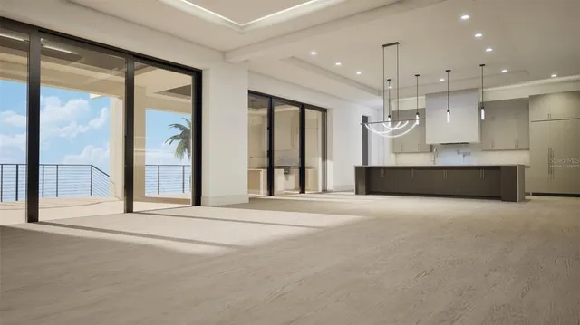 an empty room with a large window and stainless steel appliances