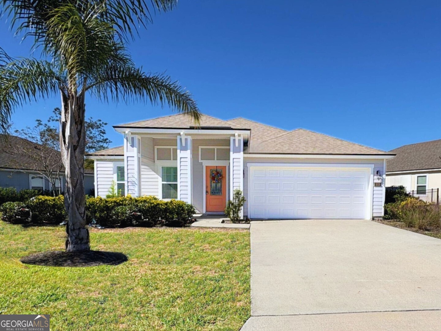 a front view of house with yard and green space