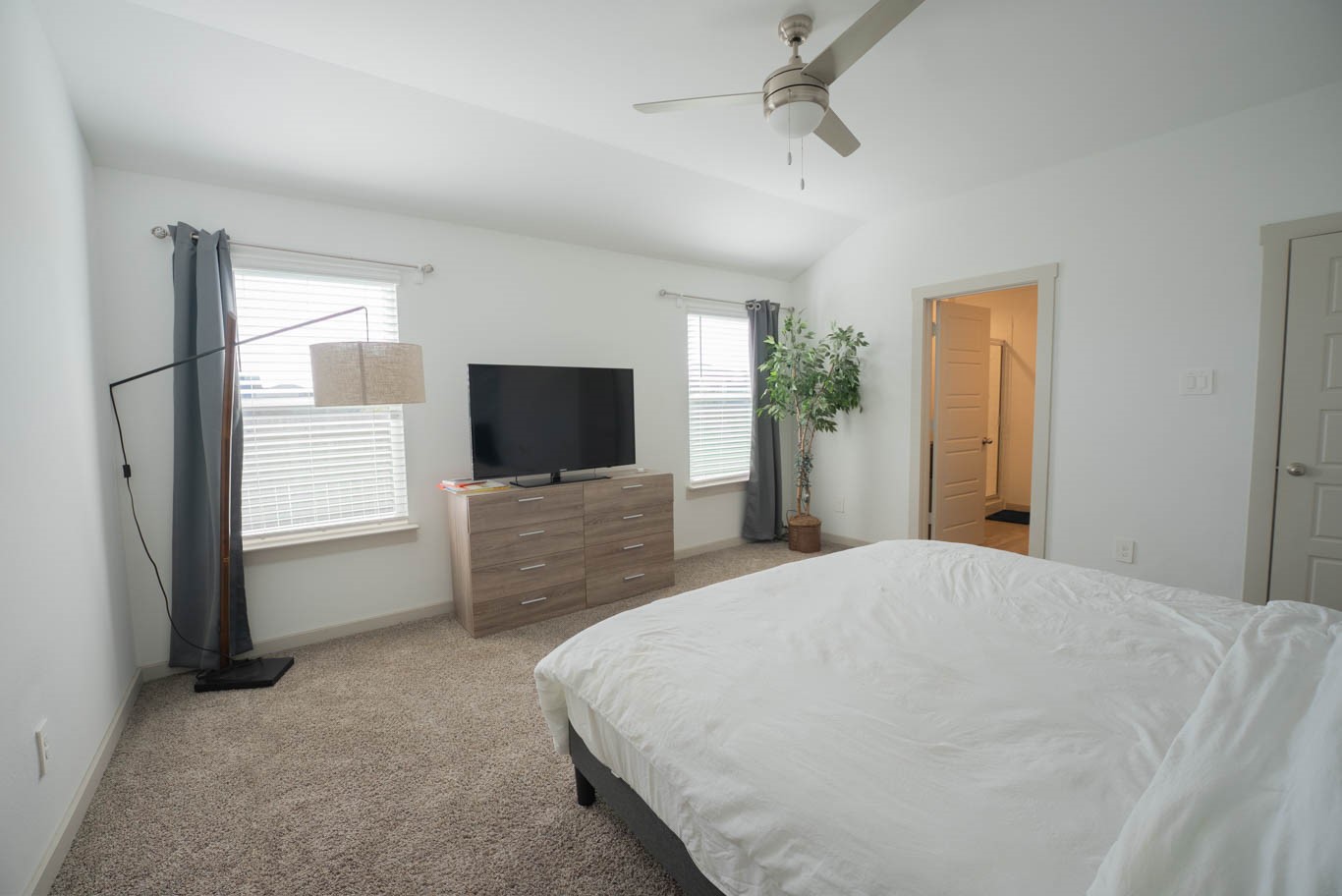 12732 Basinghall Lane Houston, TX 77047 - Photo 11 of 20 a bedroom with a bed and a flat screen tv